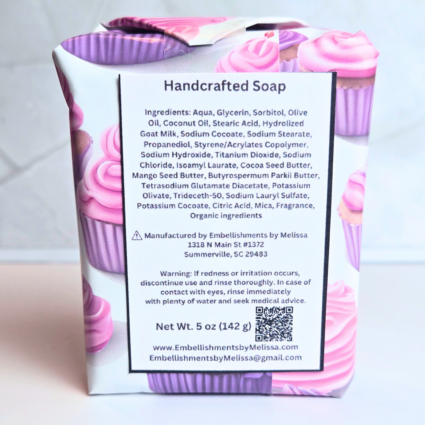 Decorative cake-inspired soap in vibrant pink and purple with buttercream piping, back view.
