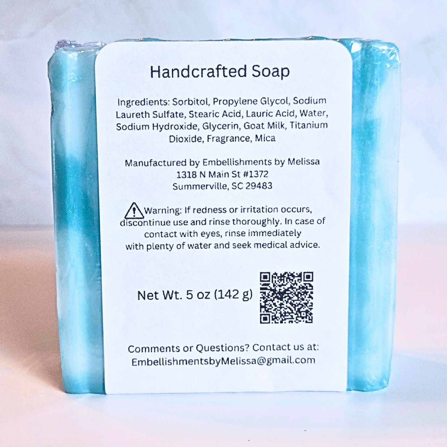 Close-up of Crystal Surf artisan soap showing swirl pattern and smooth finish, back view.