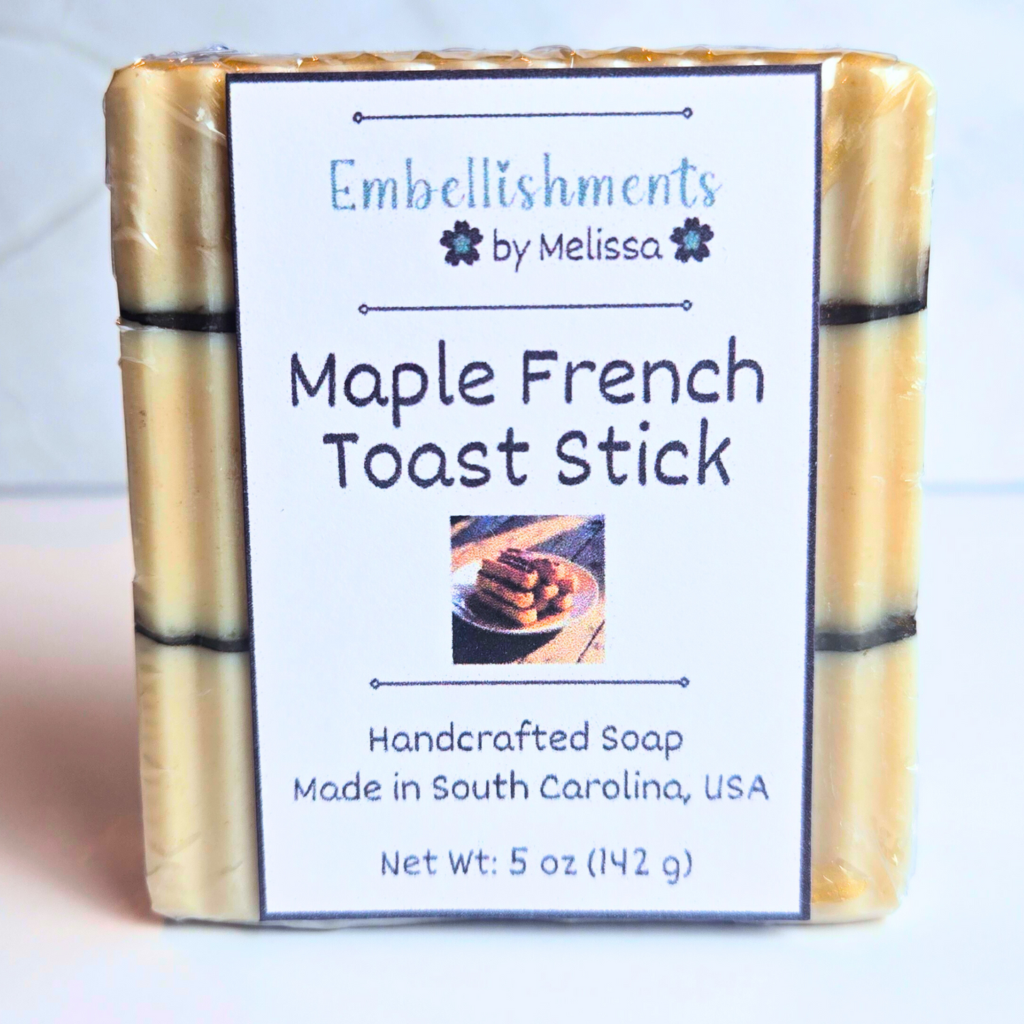 Unique handmade soap designed to resemble maple-drenched French toast sticks, front view.