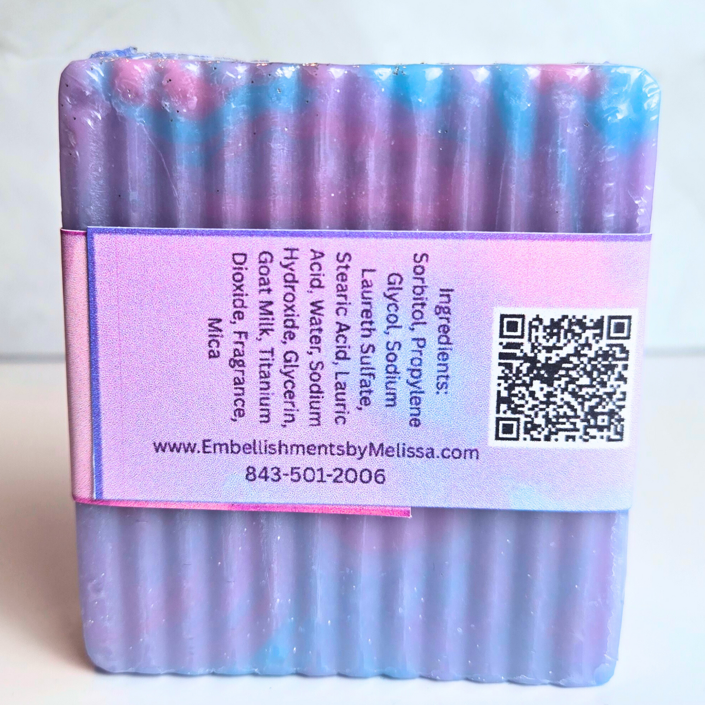 Luxury soap bar with pastel shimmer and colorful marbled swirls, back view.