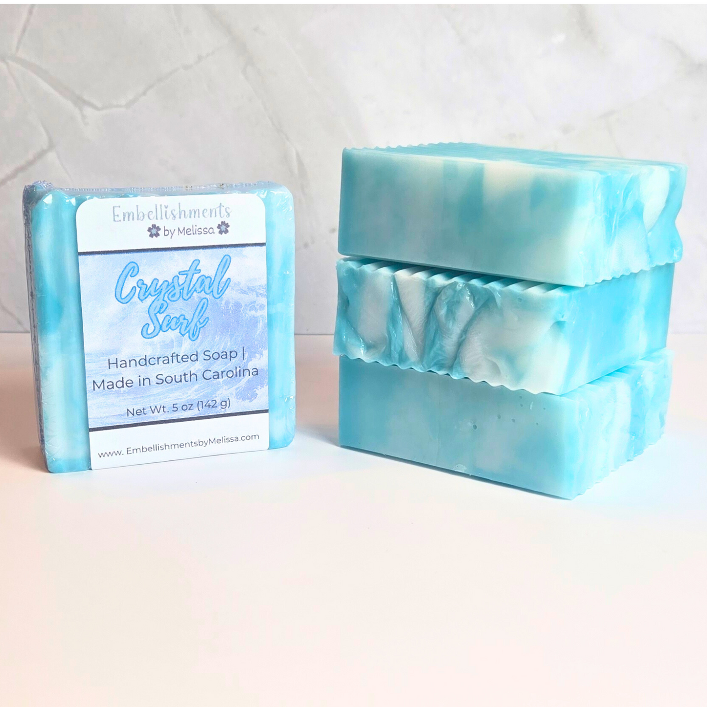 Artisan soap bar with soft ocean tones.