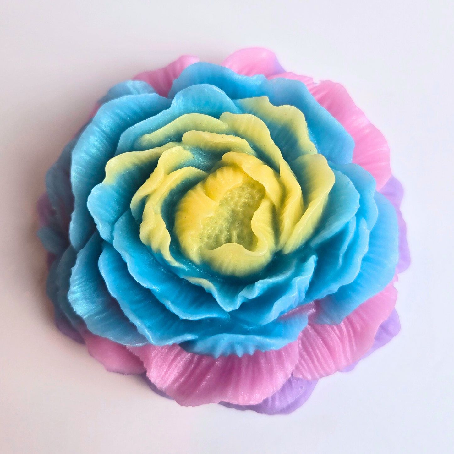 Colorful unicorn-themed soap bar with sweet and fruity fragrance, top view.