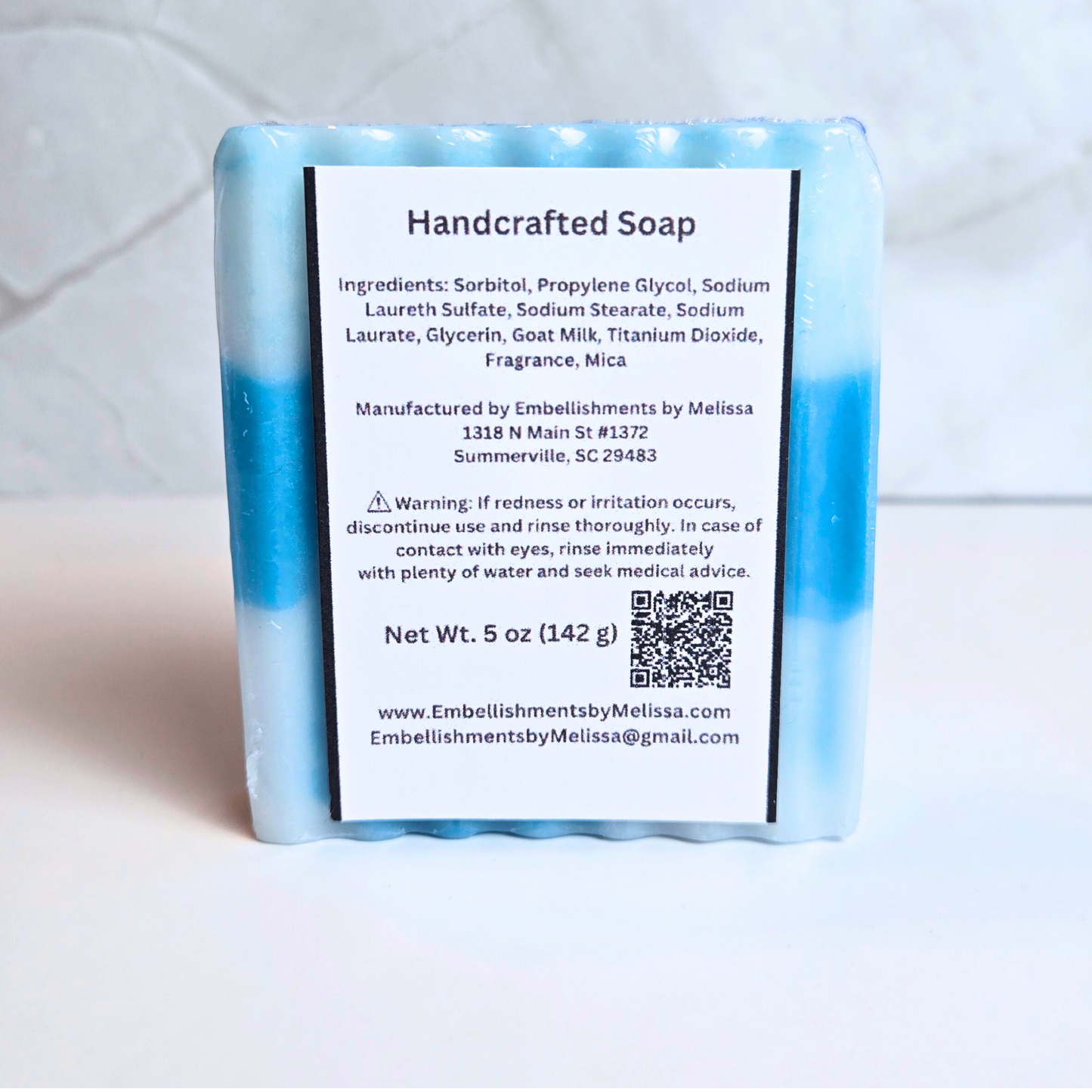 Blue and white swirled soap bar with delightful candy concoction fragrance, back view.