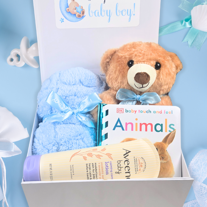 Brown teddy bear with blue bow for baby boy.