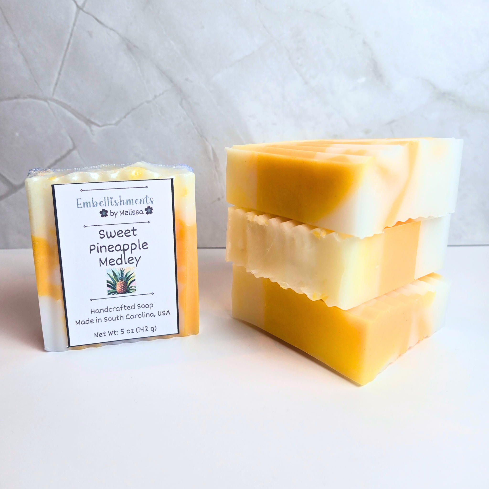 Handcrafted sweet pineapple medley soap bar with tropical fruit design, front view.