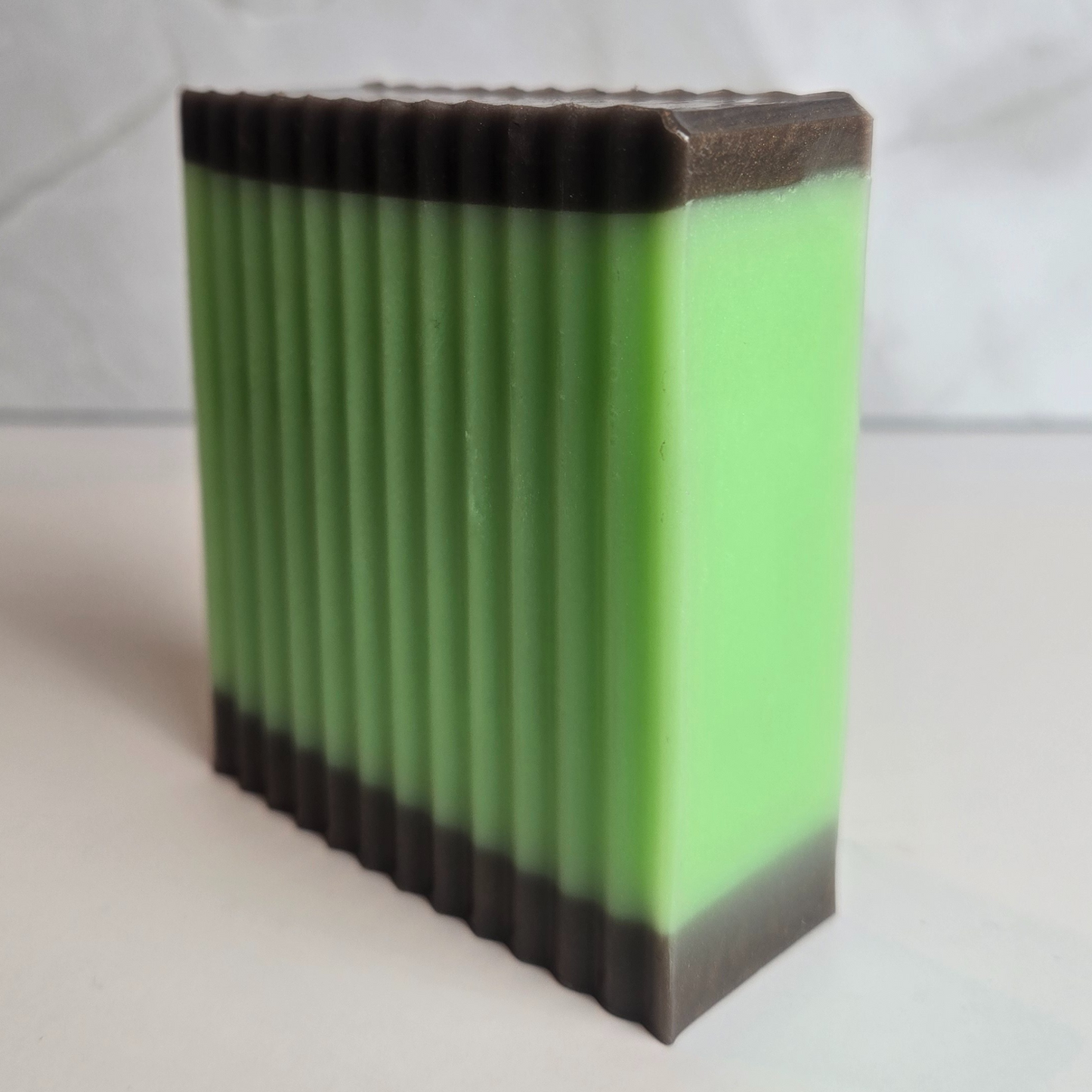 Gourmet-looking soap with caramel apple scent and layered colors, side view.