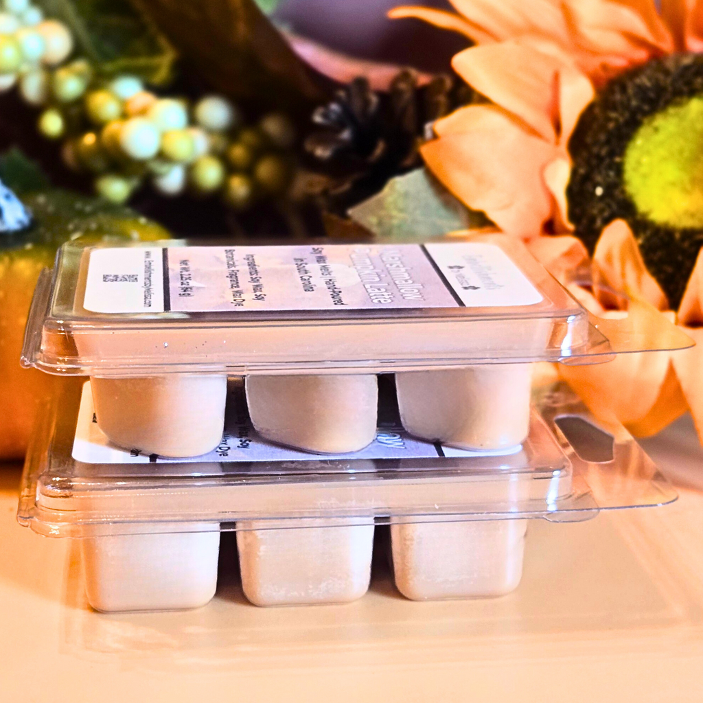 Packaged wax melts on a table with decorative elements in the background
