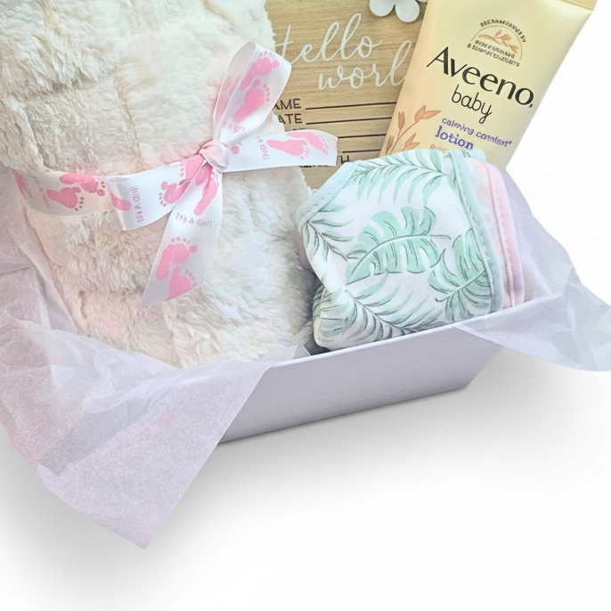 Baby gift set in a white box with a baby blanket with a pink footprint ribbon, 2 bibs, and an Aveeno baby lotion on a white background.