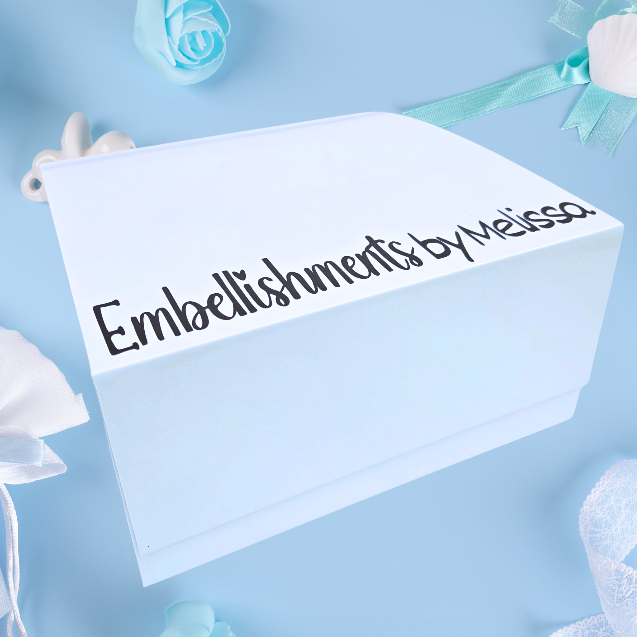 Personalized baby boy gift set with custom name on the lid, side view.