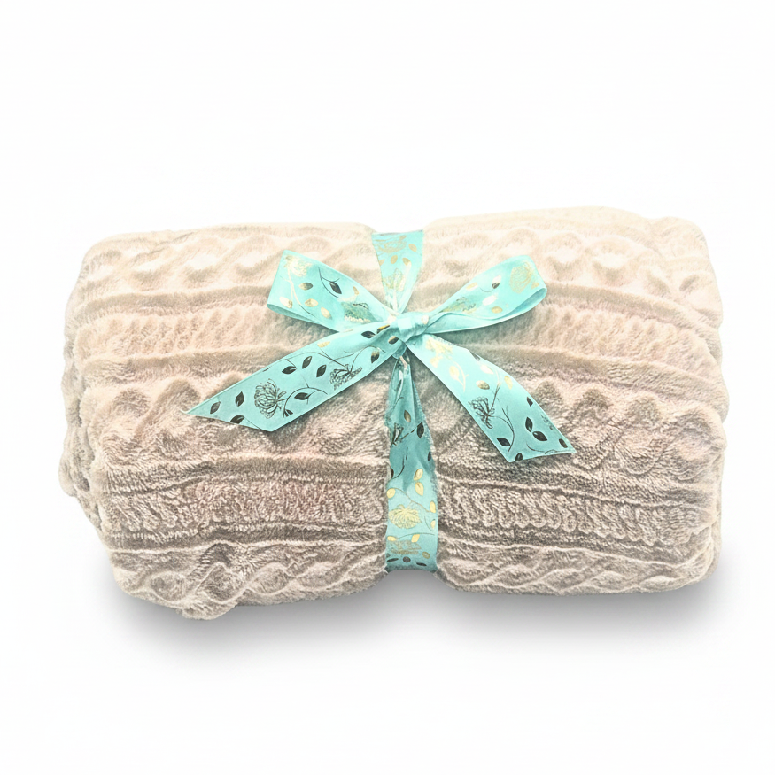 Beige textured blanket with a teal ribbon on a light background.