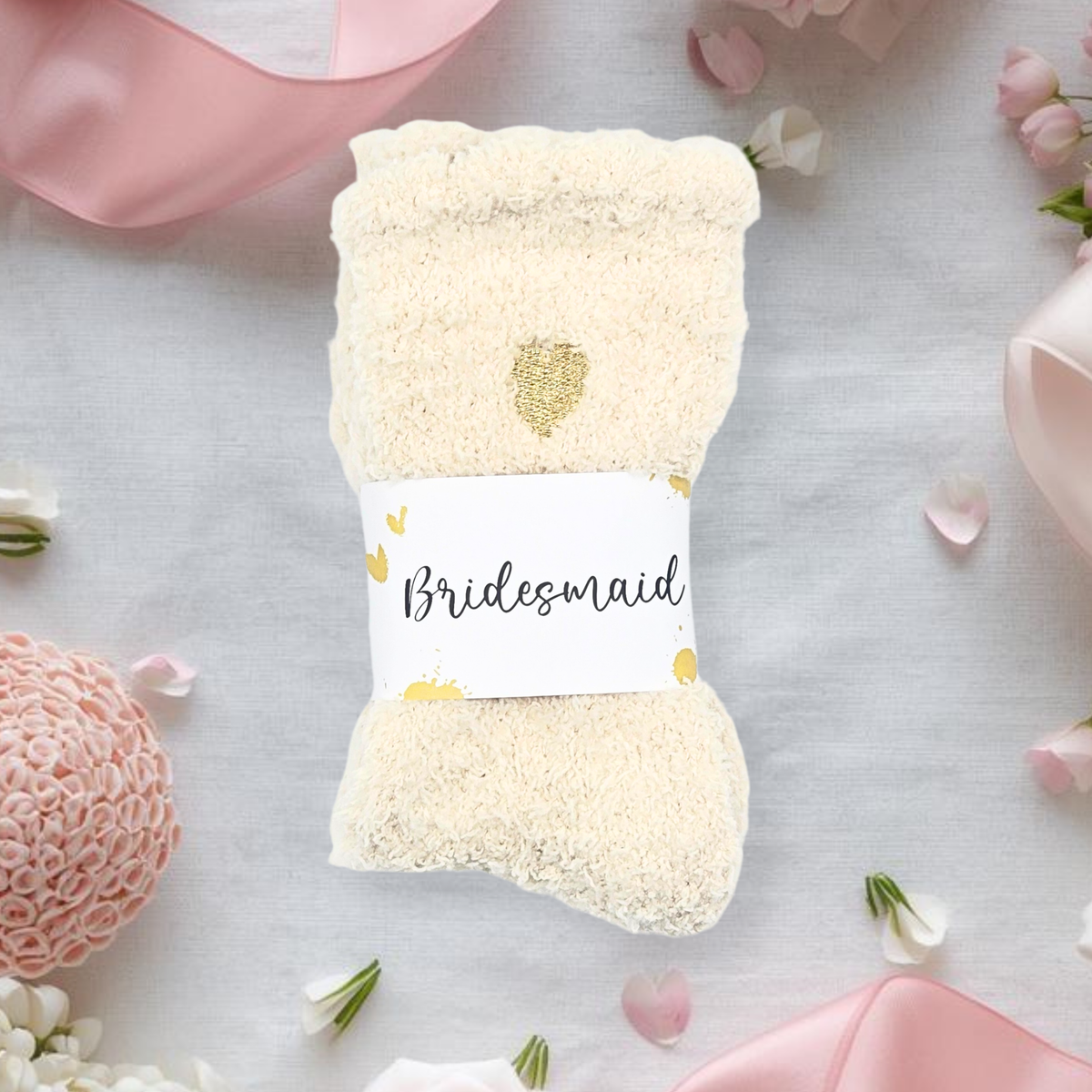 White socks with 'Bridesmaid' label on a light pink background with flowers