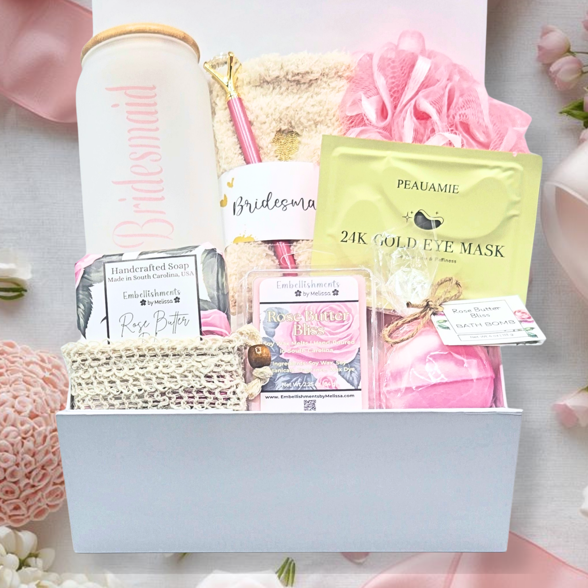 Gift box with beauty products including eye masks and soap on a floral background