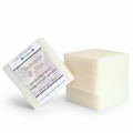 Three rectangular bars of off-white soap standing upright, with one bar leaning against them and showing a white label 'Handcrafted Soap Made in South Carolina.'