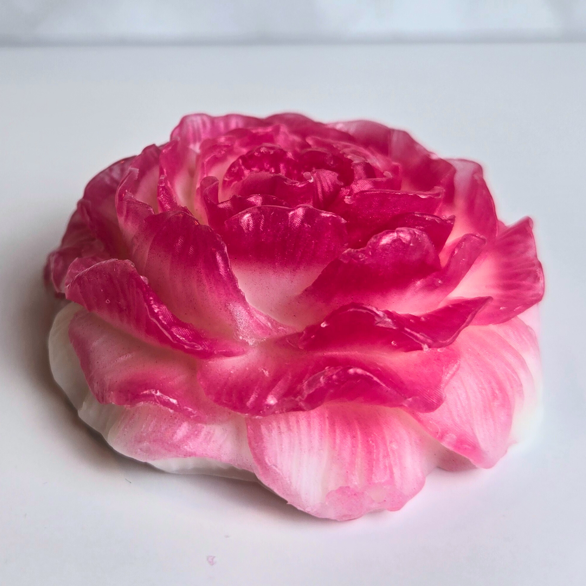 Handcrafted flower-shaped soap infused with cherry blossom fragrance, front view.