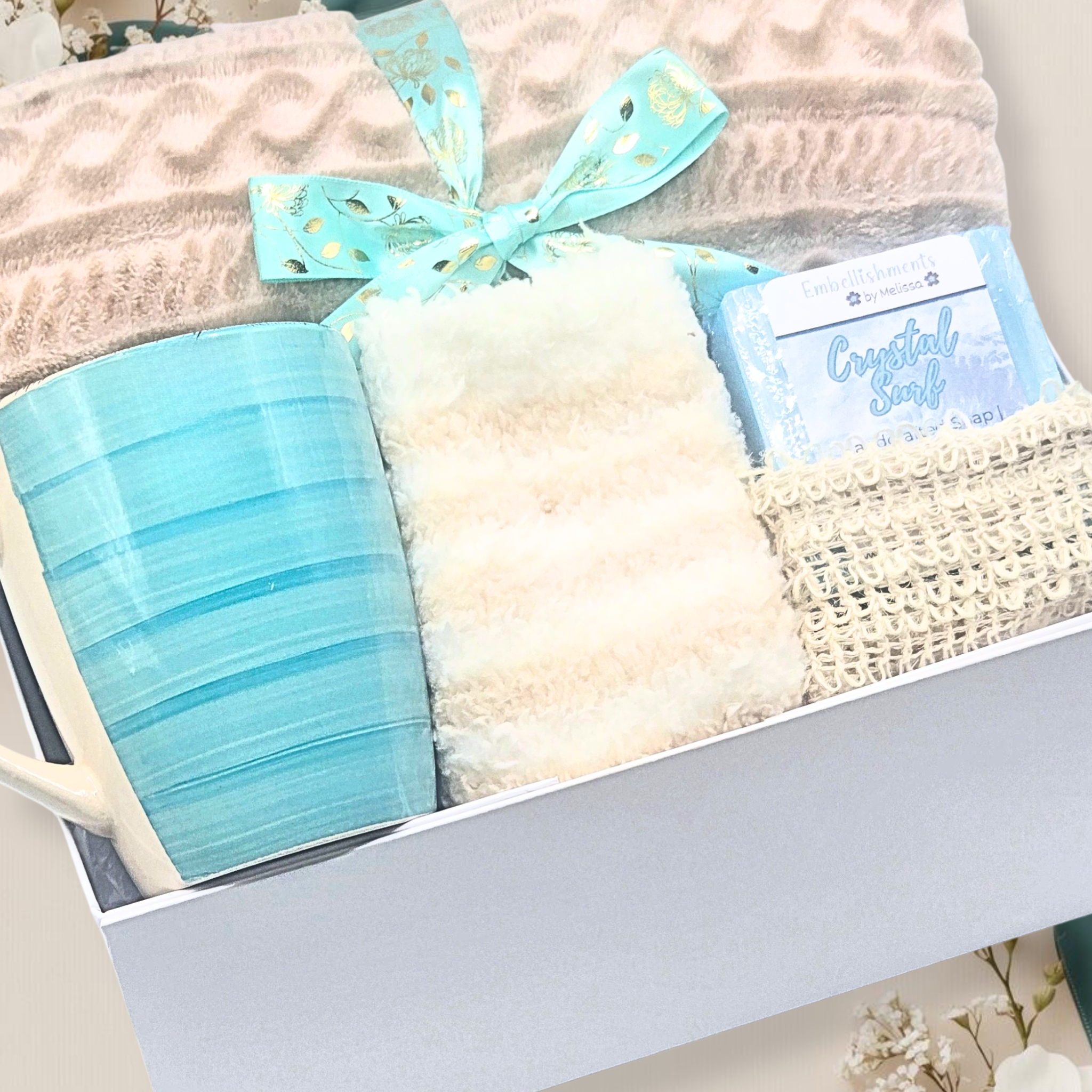 Gift set with a mug, blanket, and and handcrafted soap in a box.