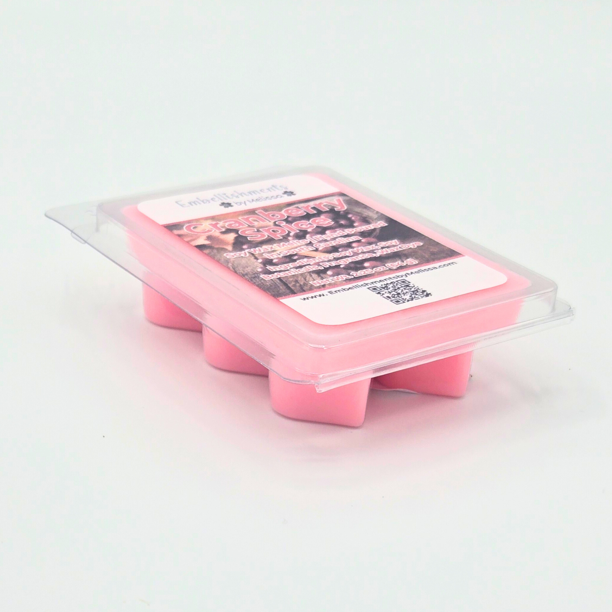Pink wax melt packaging with a label on a light white background