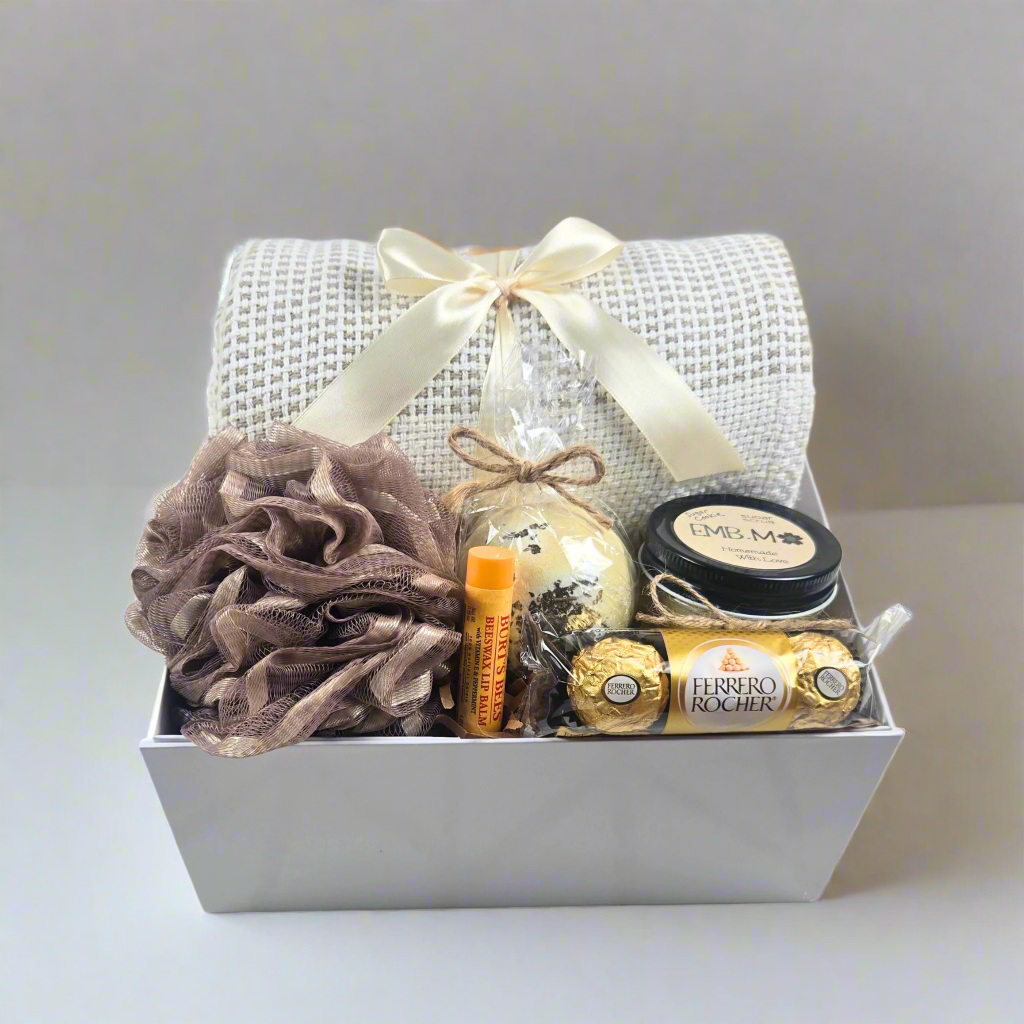 Birthday gift box for her with throw, bath pouf, bath bomb, lip balm, sugar scrub and chocolates.