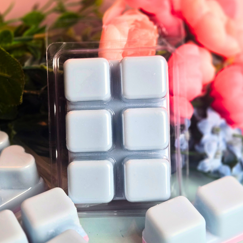 Handmade cotton candy-scented wax melts in pastel pink and blue hues.