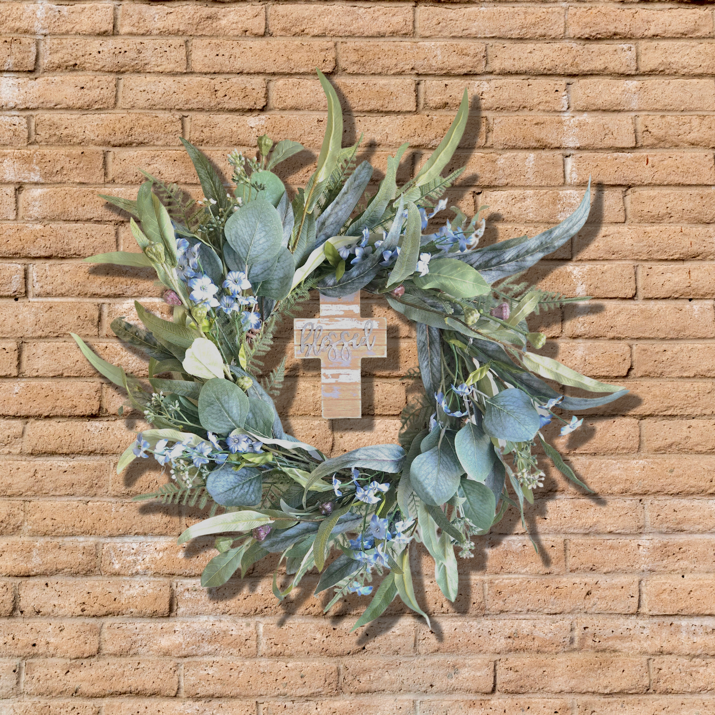 Small year round wreath featuring a cross, front view.