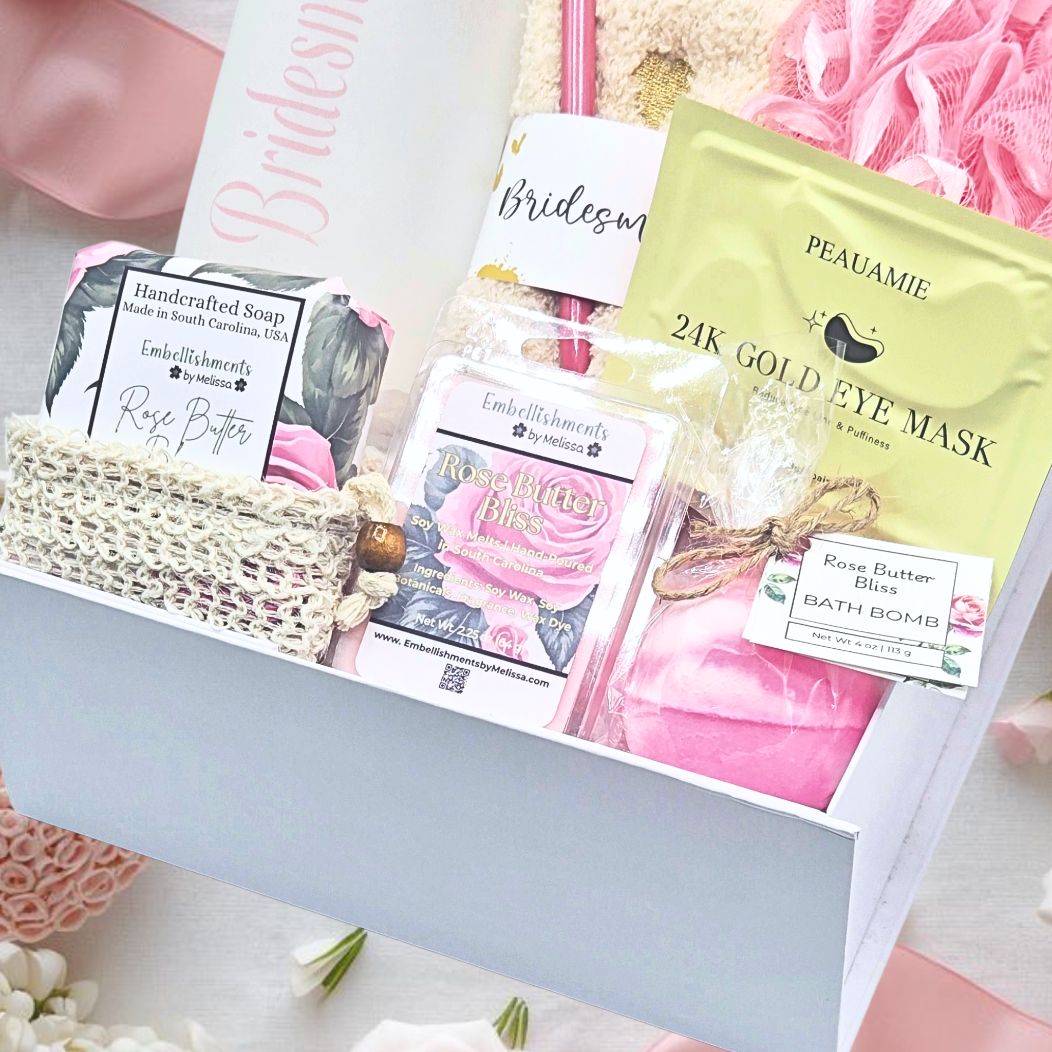 Gift box with beauty products including eye masks and soap on a floral background