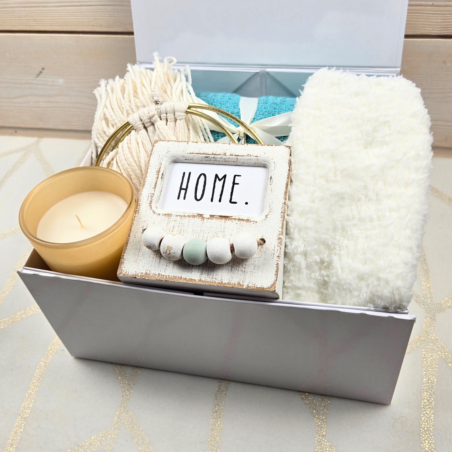 Boho-style gift box for her with decor, throw, fuzzy socks and candle.