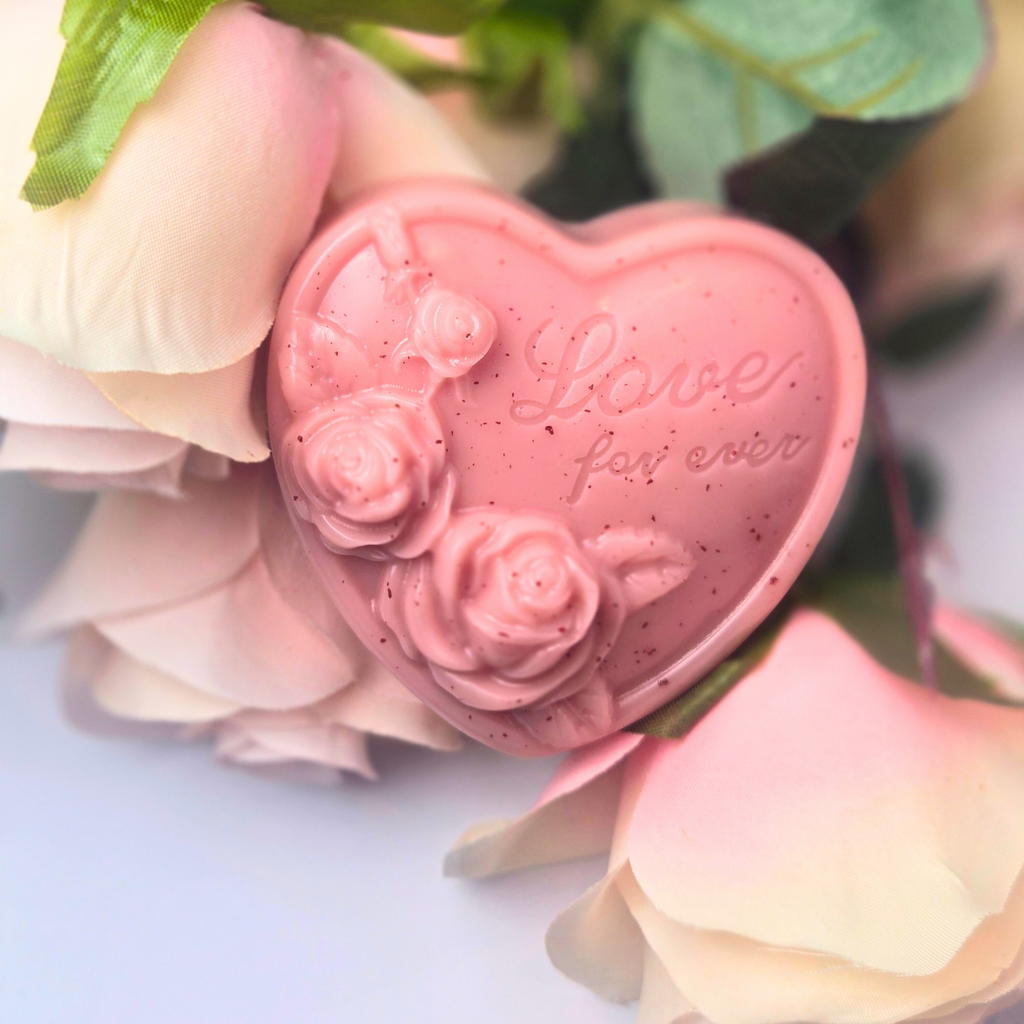 Close-up of heart-shaped goat milk soap scented with Love Spell, front view.