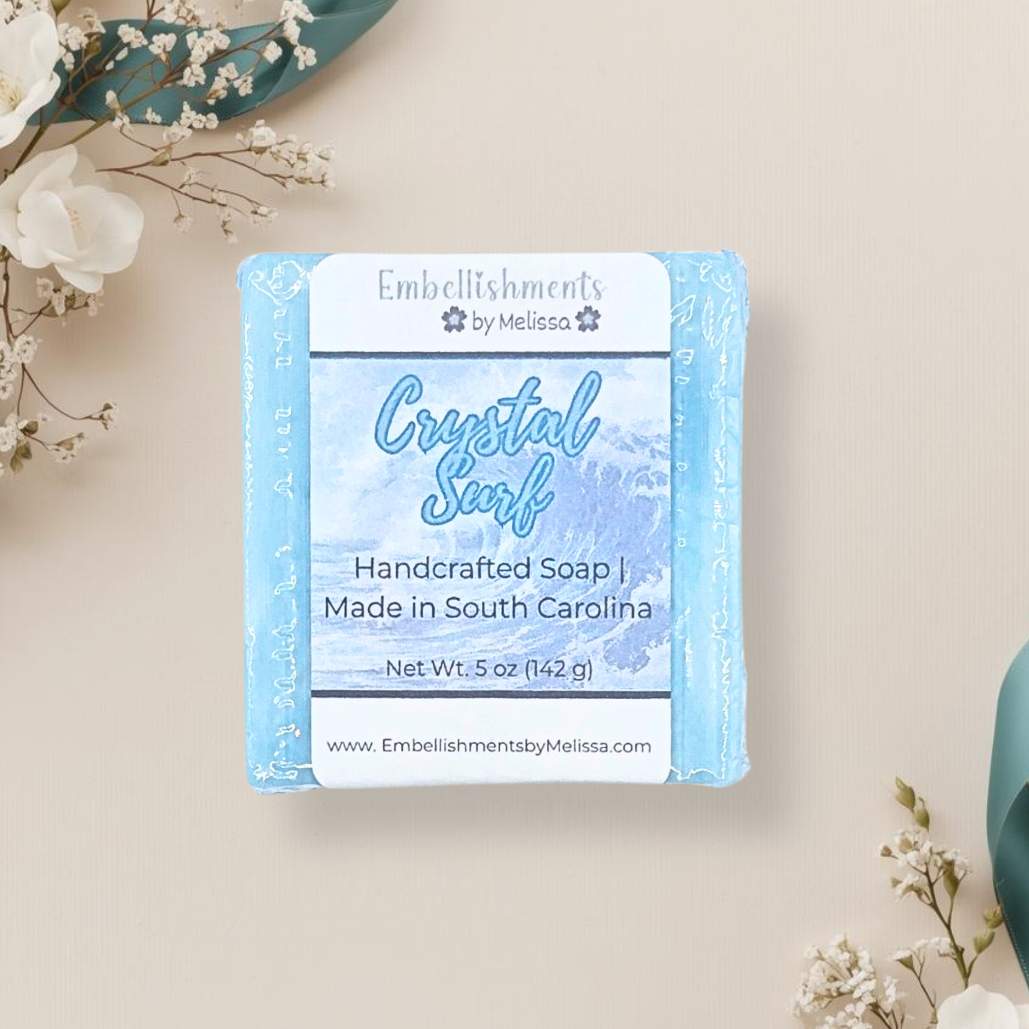 Handcrafted soap packaging with floral decorations on a light background