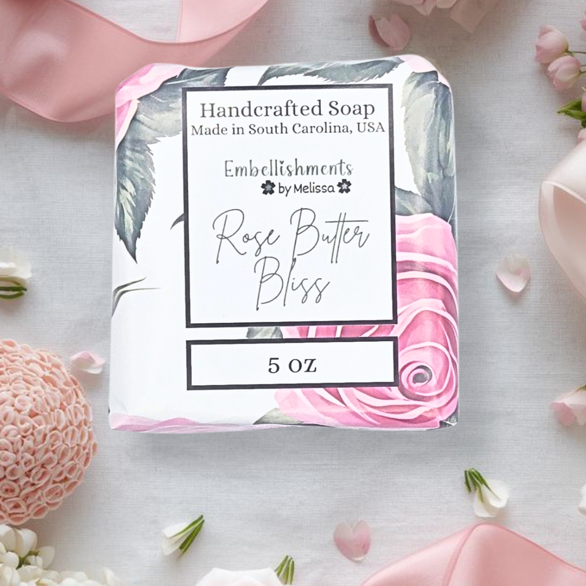 Handcrafted soap packaging with floral design and text on a light background