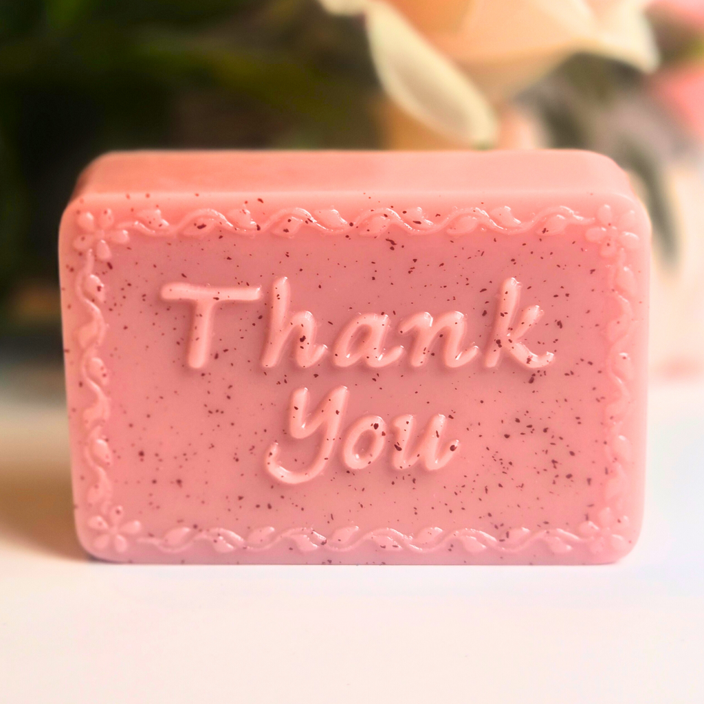 Handcrafted soap bar with rose kaolin clay and Love Spell scent, styled as a wedding favor, front view.