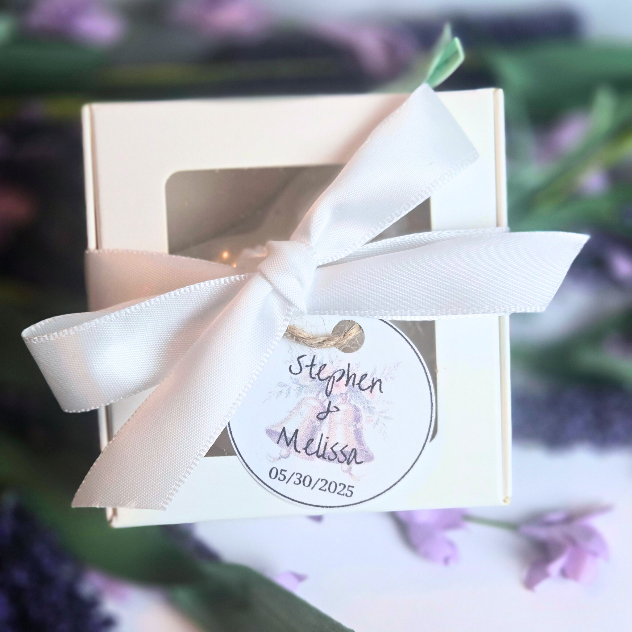 Close-up of lavender soap with heart shape and smooth creamy texture with custom tag for names and date, front view.