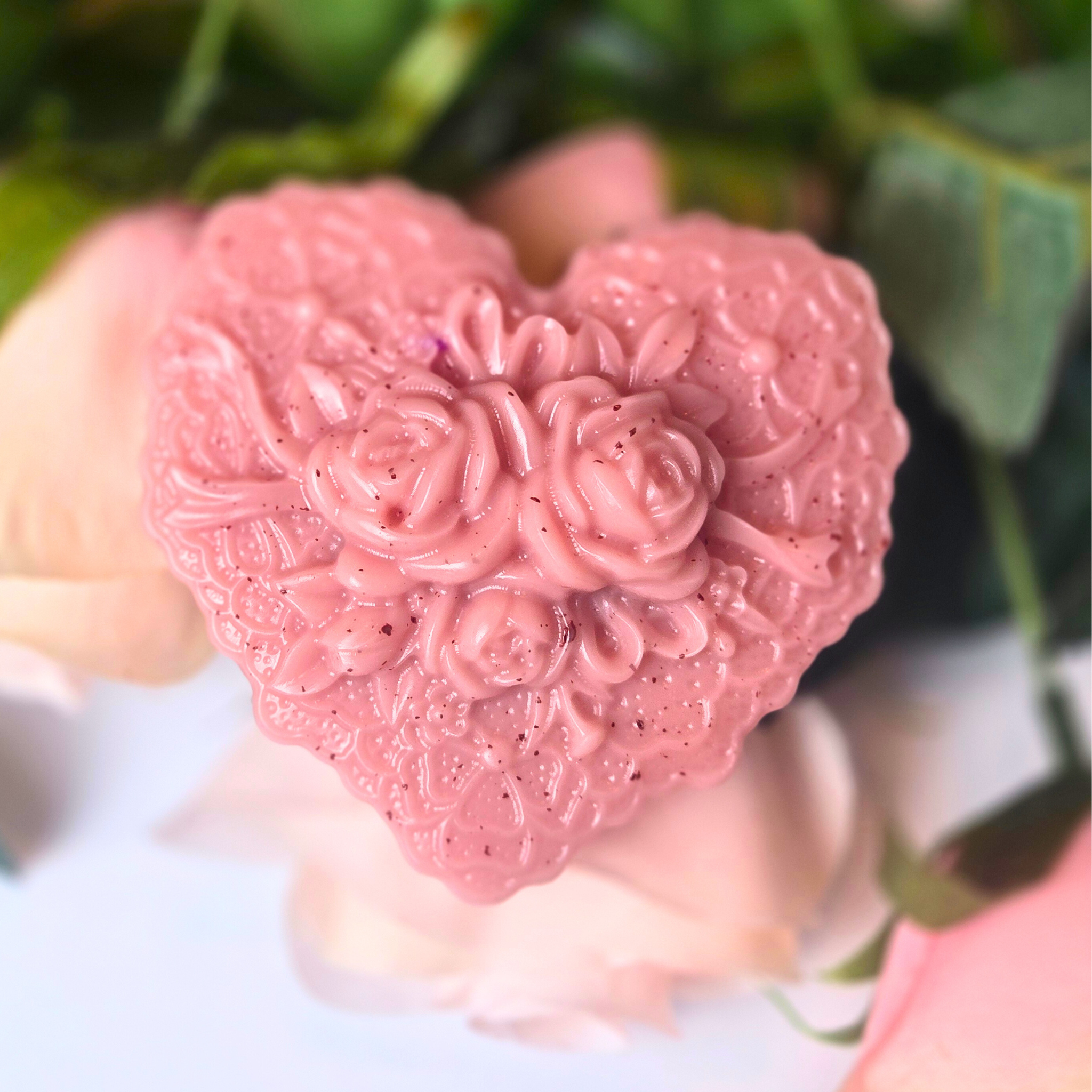 Handcrafted heart-shaped goat milk soap bar with Love Spell fragrance, front view.