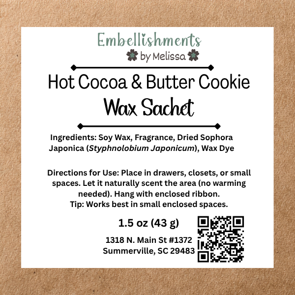 A square white product label for 'Hot Cocoa & Butter Cookie Wax Sachet' by Embellishments by Melissa, displayed on a brown kraft paper background. The label details the ingredients, directions, size.