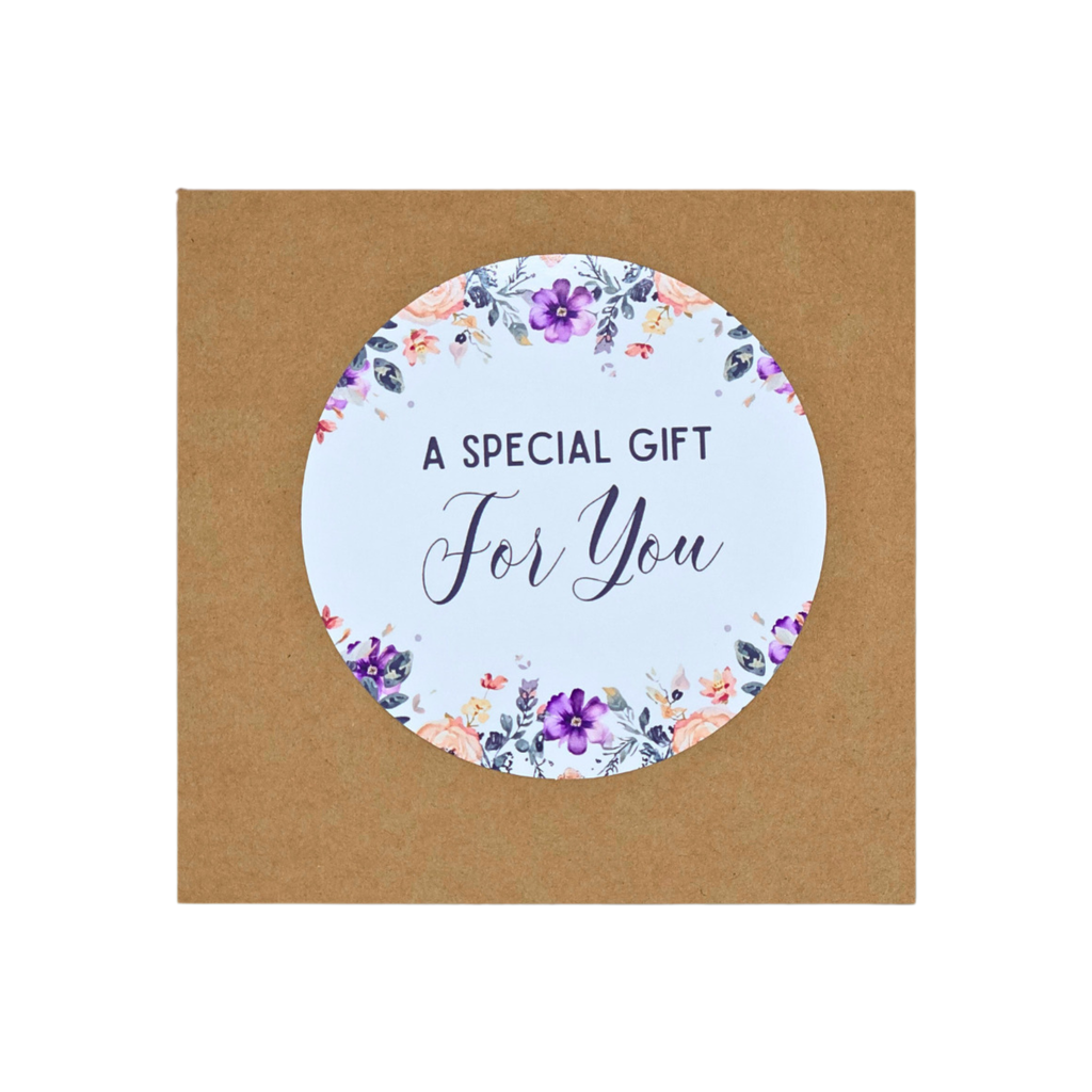 A square brown kraft paper gift card with a circular white sticker in the center that reads 'A SPECIAL GIFT For You', surrounded by a watercolor floral border in purple, pink, and green.