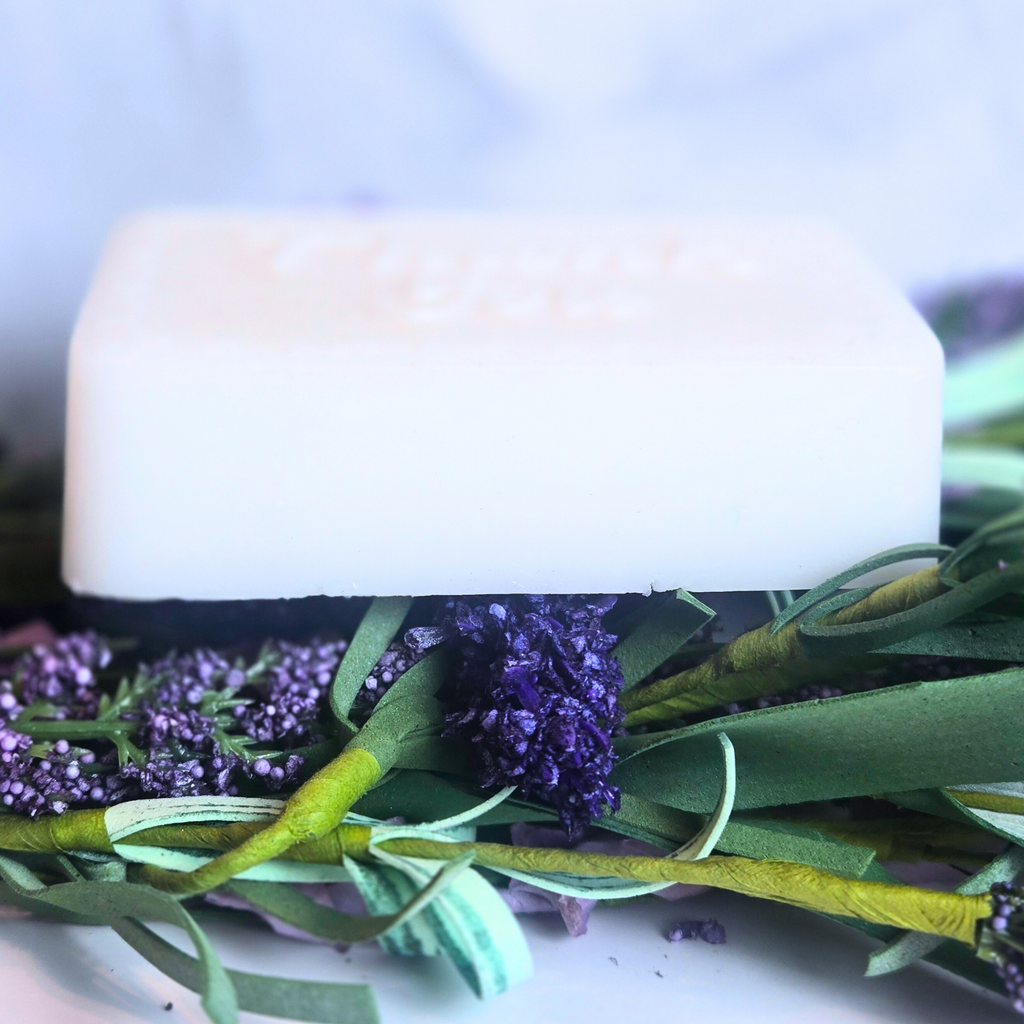 Close-up of lavender and white clay soap used as bridal shower favor, side view.
