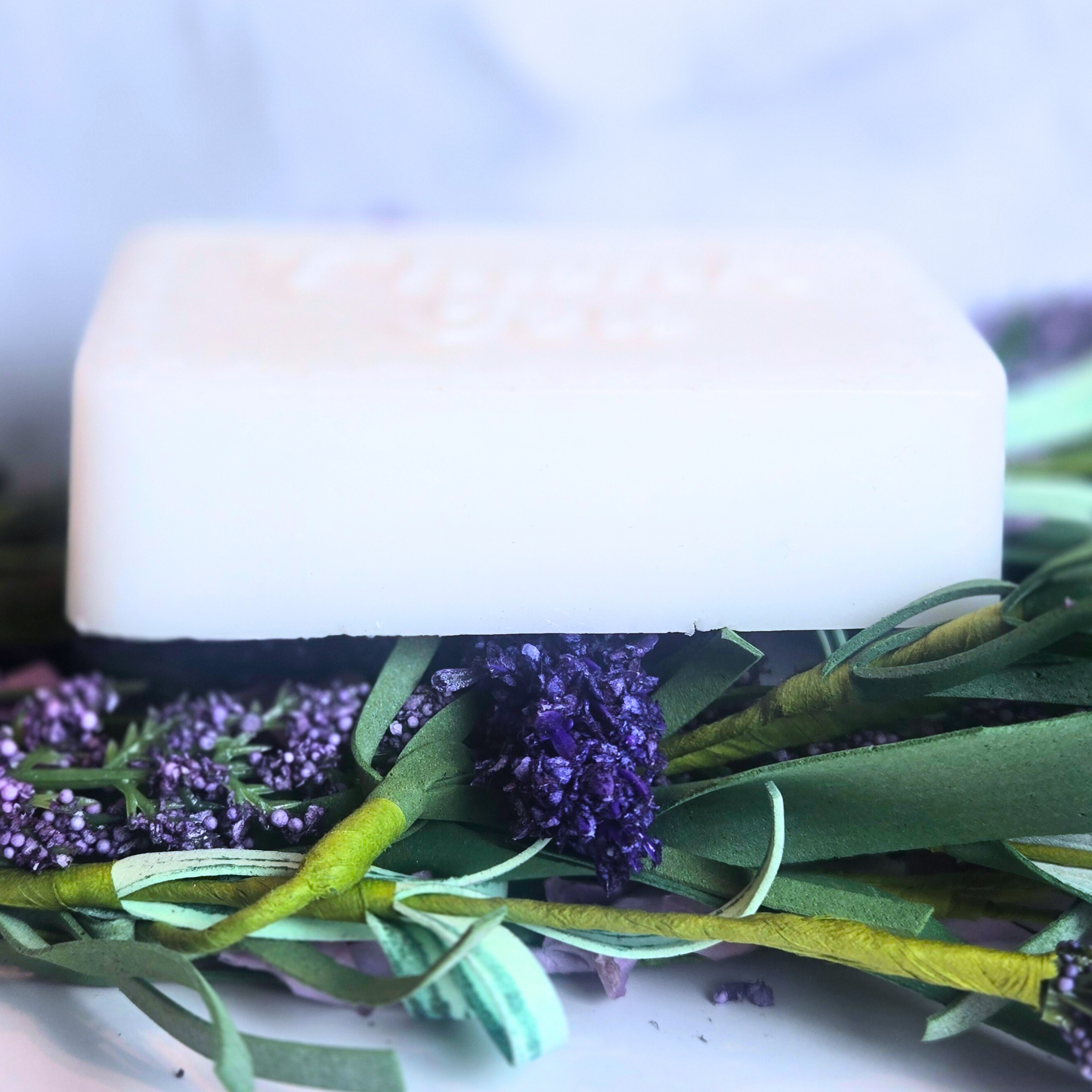 Close-up of lavender and white clay soap used as bridal shower favor, side view.