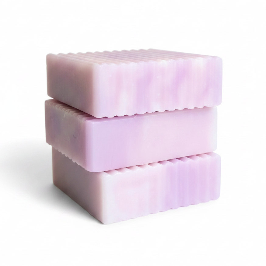 Three stacked rectangular bars of lavender soap with a wavy scalloped edge, shown on a clean white background.