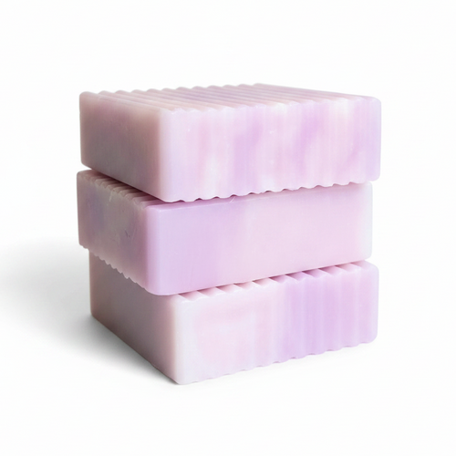 Three stacked rectangular bars of lavender soap with a wavy scalloped edge, shown on a clean white background.