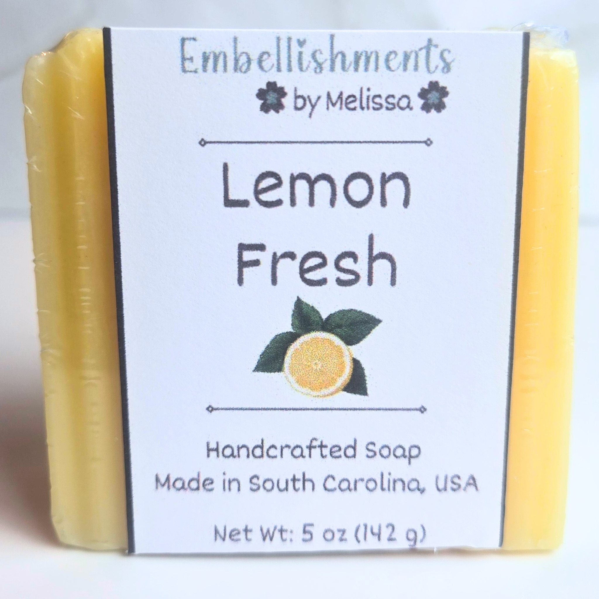 Citrusy lemon-scented handmade soap in vibrant yellow color, front view.