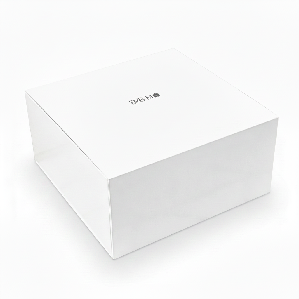 A plain white square product box with a small black logo printed on the top lid, photographed on a clean white background.