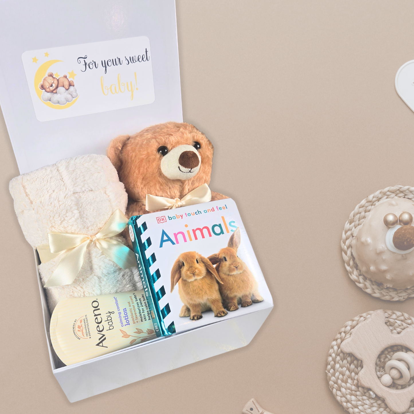 Gender neutral baby shower gift box including beige baby blanket, stuffed bear, touch and feel baby book and lavender baby lotion.