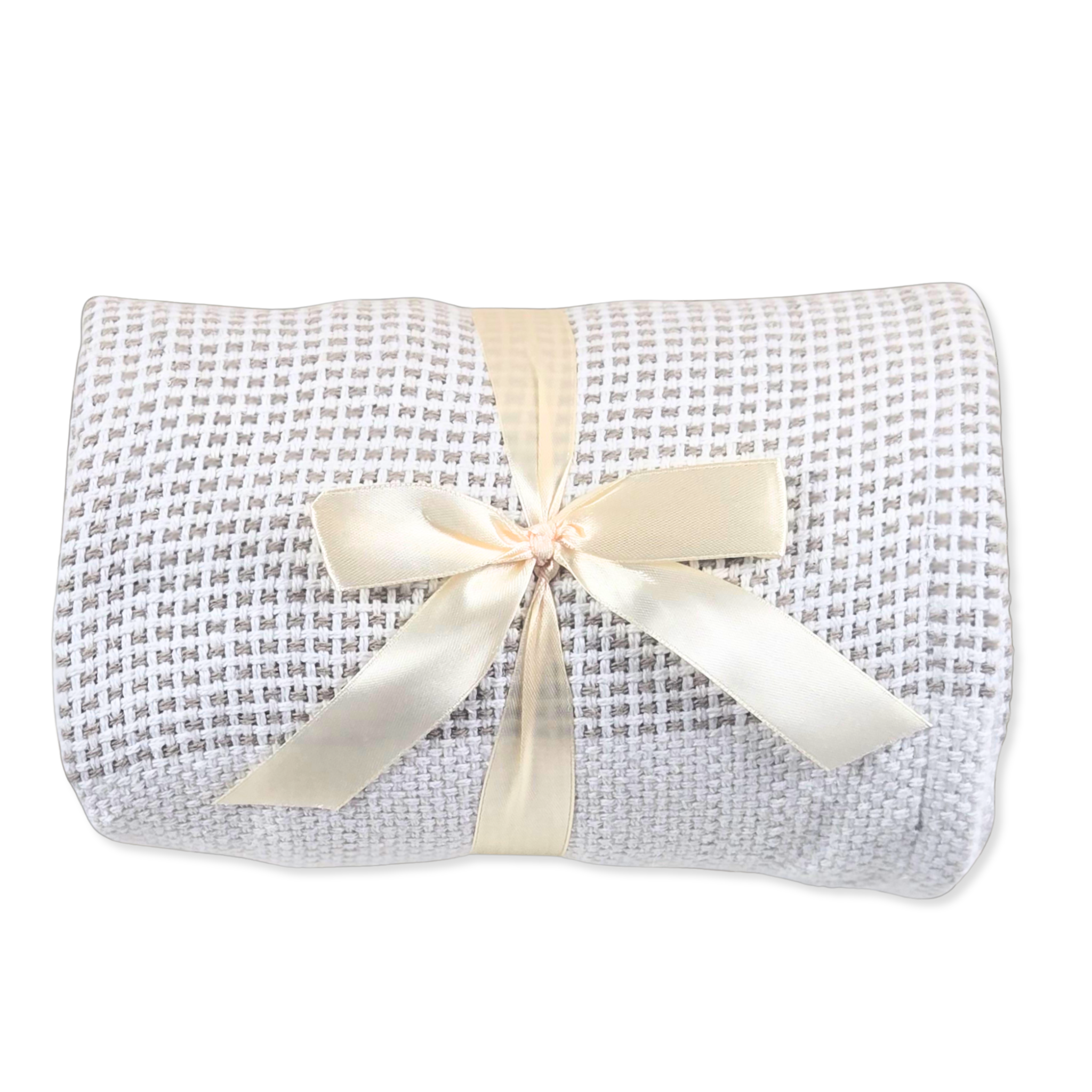 A blanket with a lbeige and white pattern, wrapped in a cream satin ribbon with a bow, on a white background.
