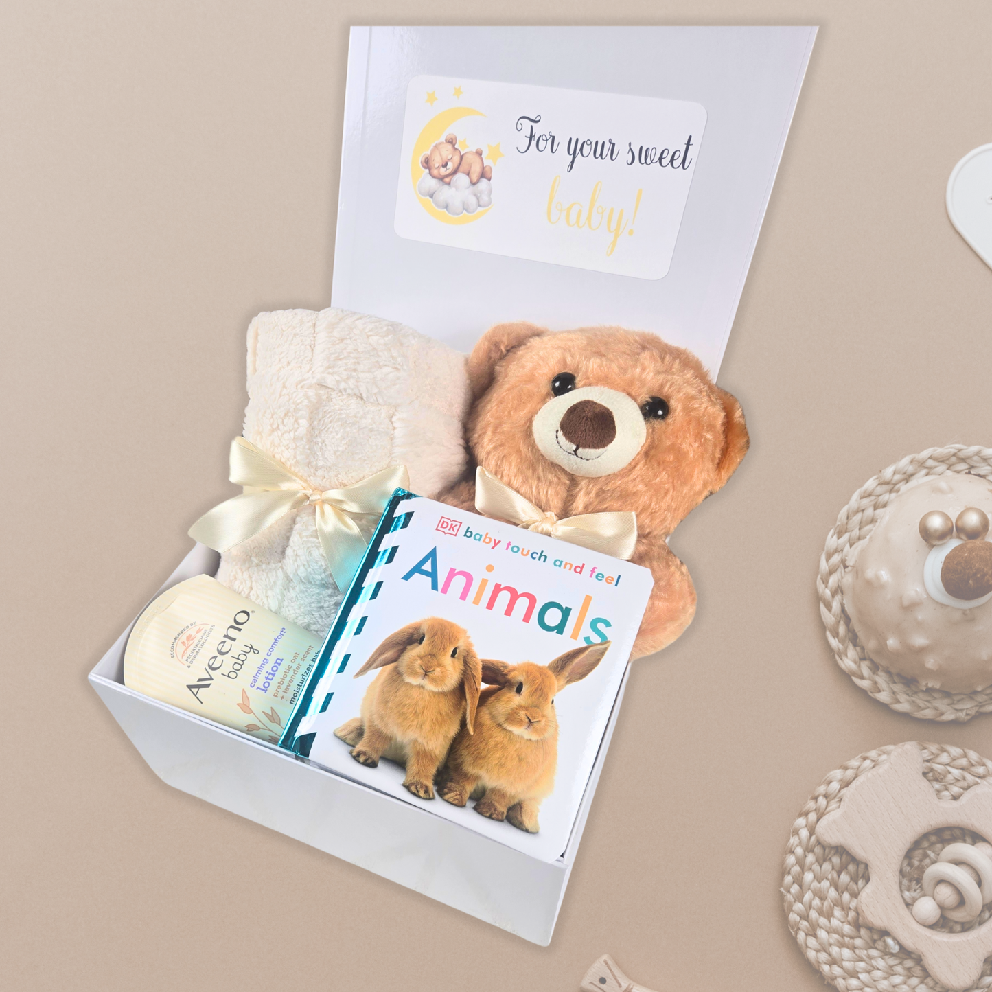 Gender neutral baby shower gift box including beige baby blanket, stuffed bear, touch and feel baby book and lavender baby lotion.