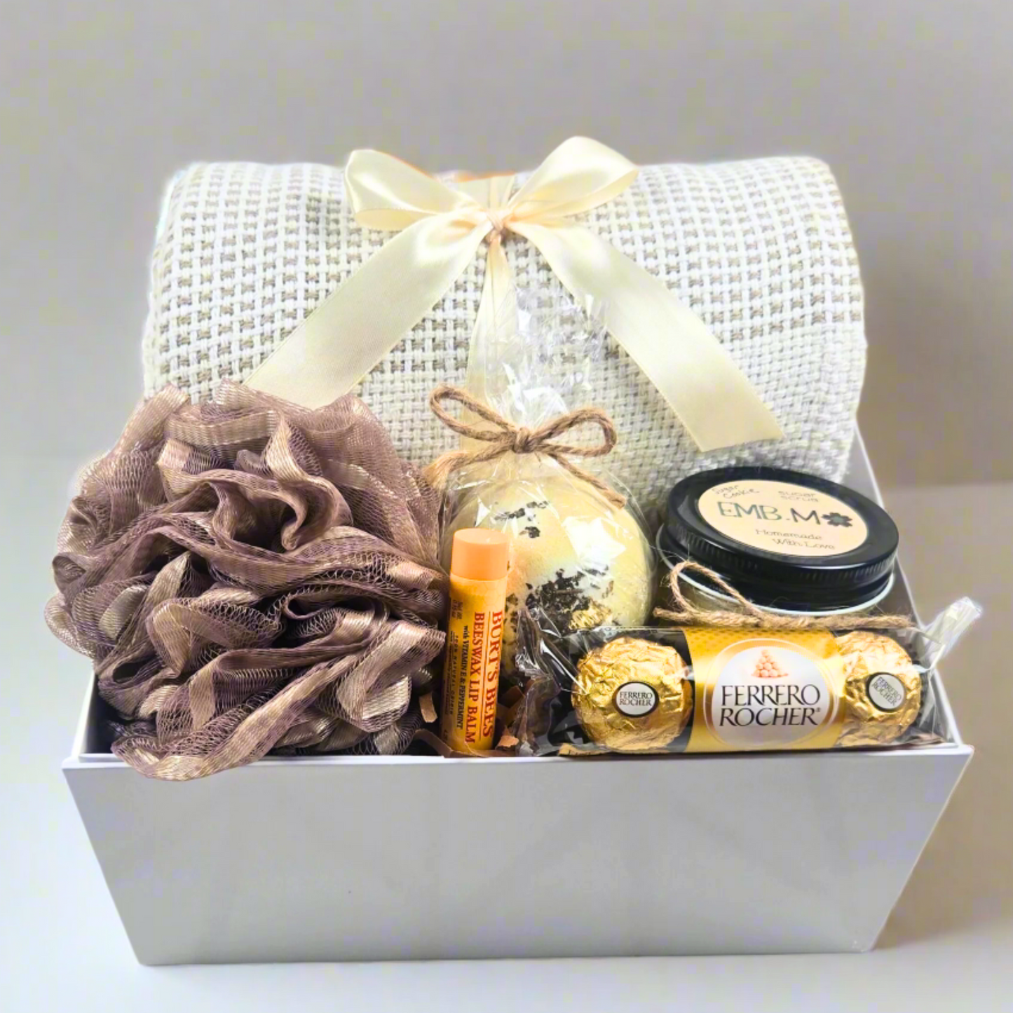 Birthday gift box for her with throw, bath pouf, bath bomb, lip balm, sugar scrub and chocolates.