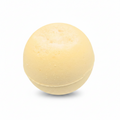 A single pale yellow bath bomb with a textured, porous surface, isolated on a solid white background.