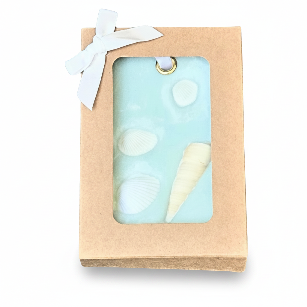 Ocean-themed wax sachet in kraft box with bow.