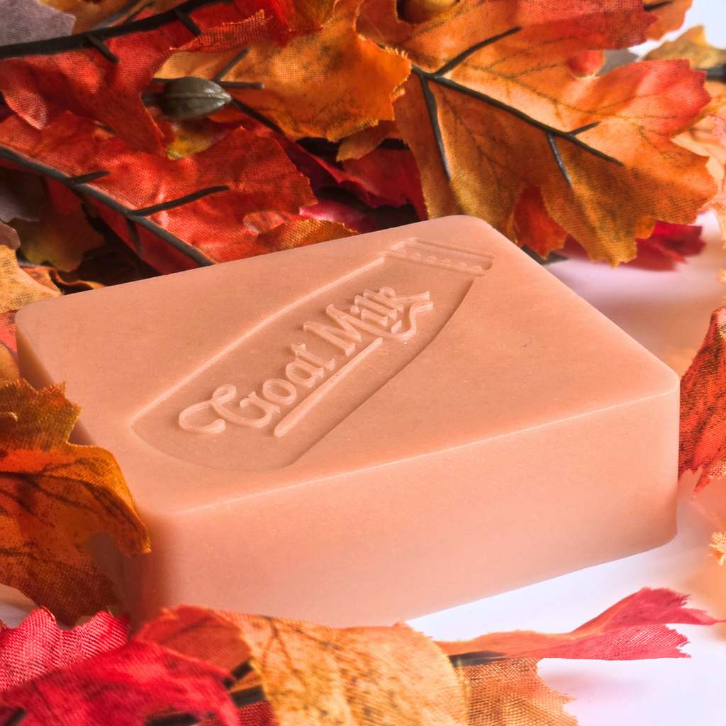 Handcrafted goat milk soap bar with a warm pumpkin pie scent, side view.