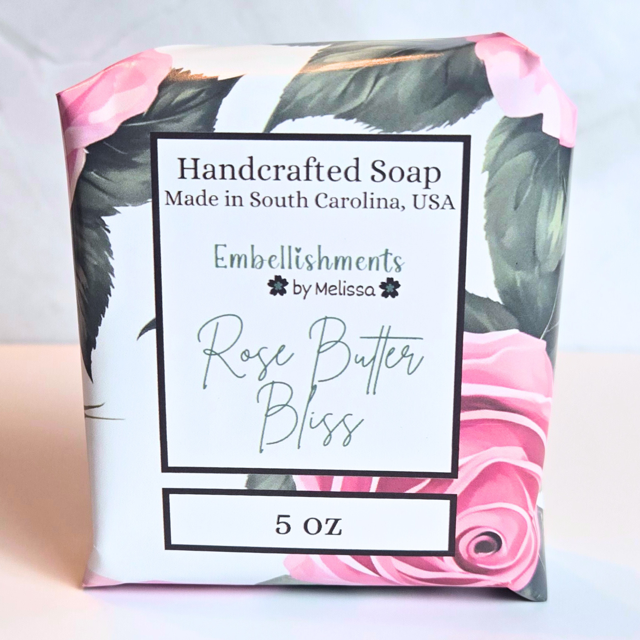 Rose-scented handmade soap bar with elegant swirl design, front view.