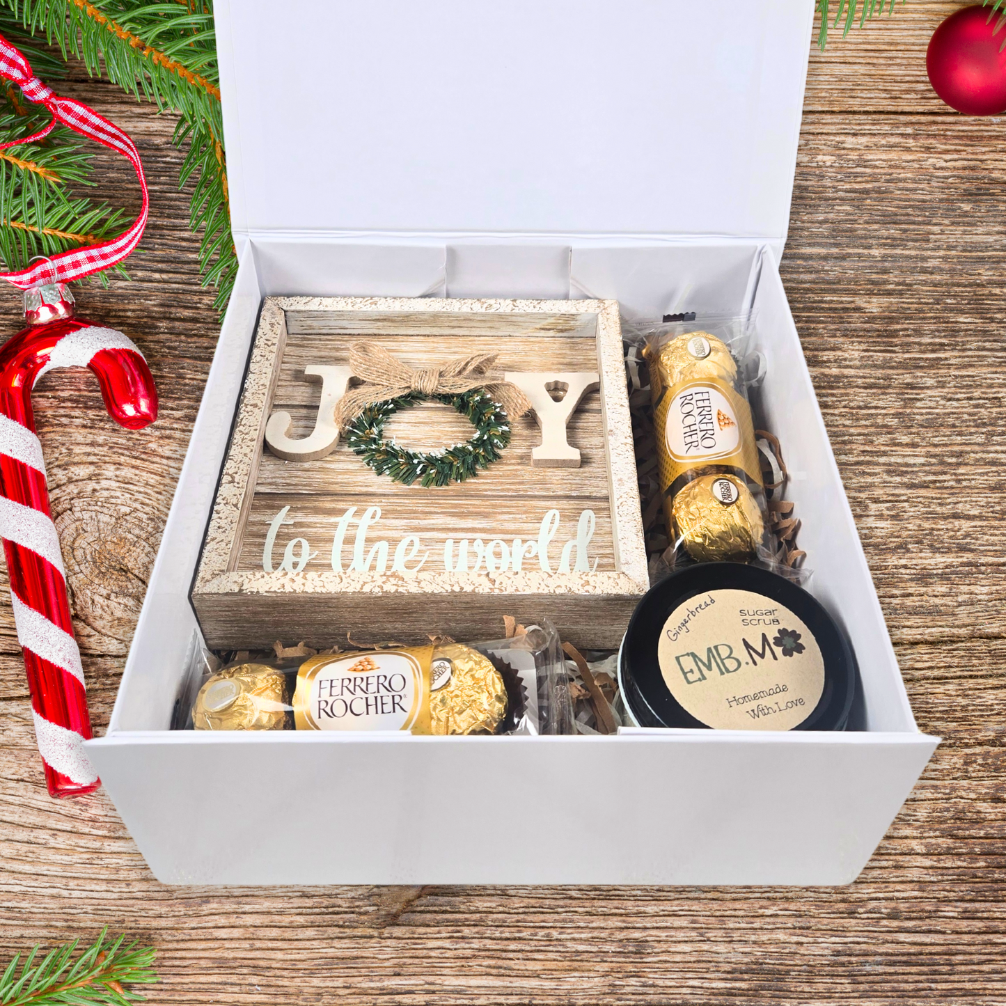 Rustic Christmas gift box with christmas decor sign, sugar scrub and chocolates.