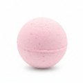 A pink spherical bath bomb with a textured, porous surface, shown against a plain white background.