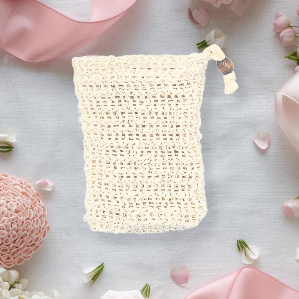 Mesh soap bag on a light surface with pink and white flowers around